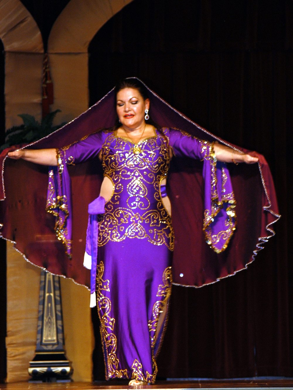 Jihan Jamal in a purple gown and head veil, arms extended, Ya Hallah Y'All, Dallas